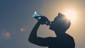 man drinking water to stay hydrated
